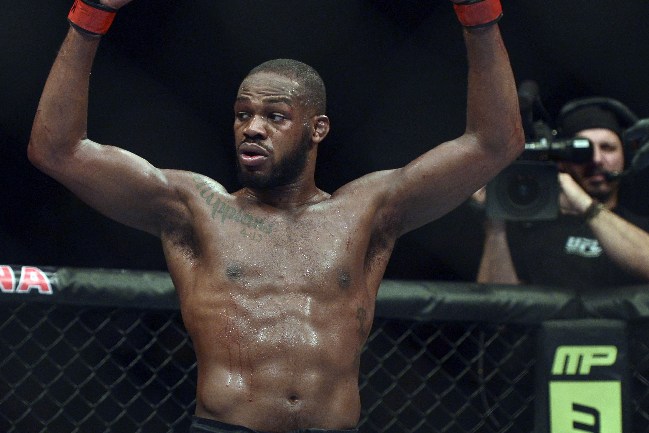 Apr 26, 2014; Baltimore, MD, USA;  Jon Jones puts his arms in the air after the UFC light heavy weight championship fight against Glover Texeira at  Baltimore Arena. Jones retained the light heavy height championship by defeating  Teixeria.  Mandatory Credit: Tommy Gilligan-USA TODAY Sports