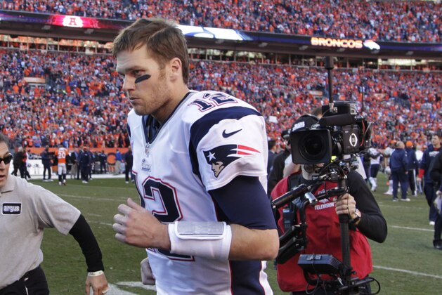 New England Patriots quarterback Tom Brady runs off the field after the AFC Championship NFL playoff football game in Denver, Sunday, Jan. 19, 2014. The Broncos defeated the Patriots 26-16 to advance to the Super Bowl. (AP Photo/Joe Mahoney)