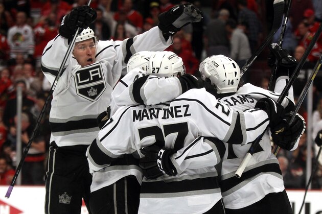 CHICAGO, IL - JUNE 01:  Tyler Toffoli #73 of the Los Angeles Kings jumps on Alec Martinez #27 and teammates after Martinez scored the game winning goal against Corey Crawford #50 of the Chicago Blackhawks in overtime 5 to 4 to win Game Seven of the Western Conference Final in the 2014 Stanley Cup Playoffs at United Center on June 1, 2014 in Chicago, Illinois.  (Photo by Justin Heiman/Getty Images)