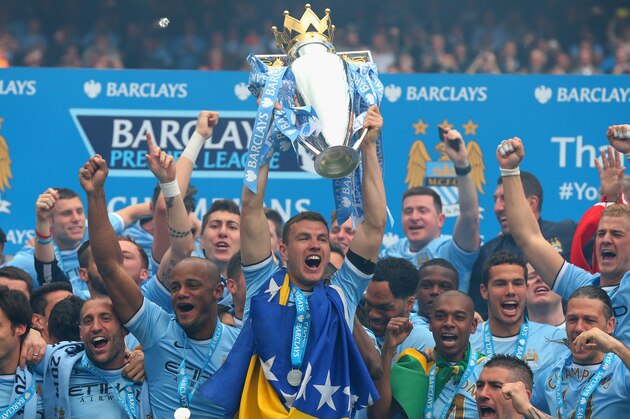 MANCHESTER, ENGLAND - MAY 11:  Edin Dzeko of Manchester City lifts the Premier League trophy at the end of the Barclays Premier League match between Manchester City and West Ham United at the Etihad Stadium on May 11, 2014 in Manchester, England.  (Photo by Alex Livesey/Getty Images)