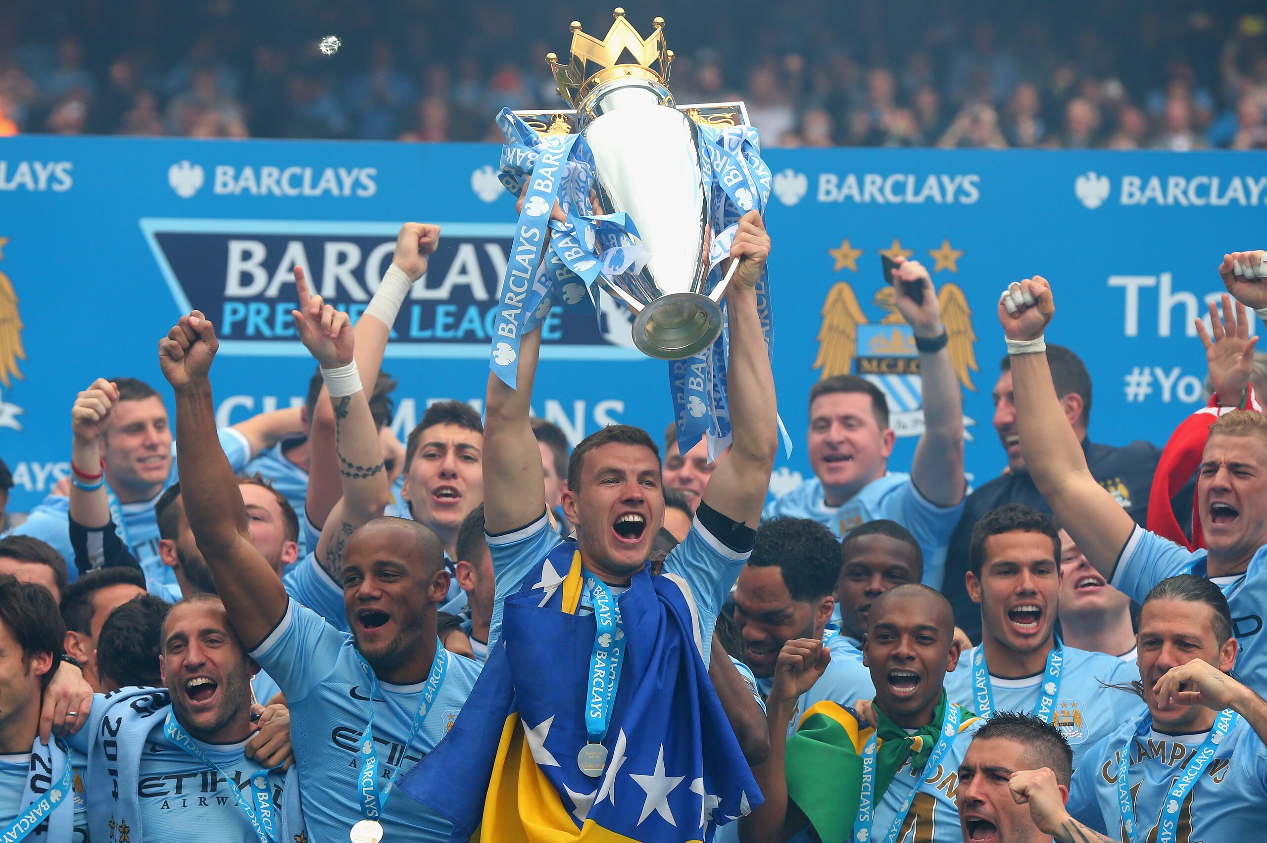 MANCHESTER, ENGLAND - MAY 11:  Edin Dzeko of Manchester City lifts the Premier League trophy at the end of the Barclays Premier League match between Manchester City and West Ham United at the Etihad Stadium on May 11, 2014 in Manchester, England.  (Photo by Alex Livesey/Getty Images)