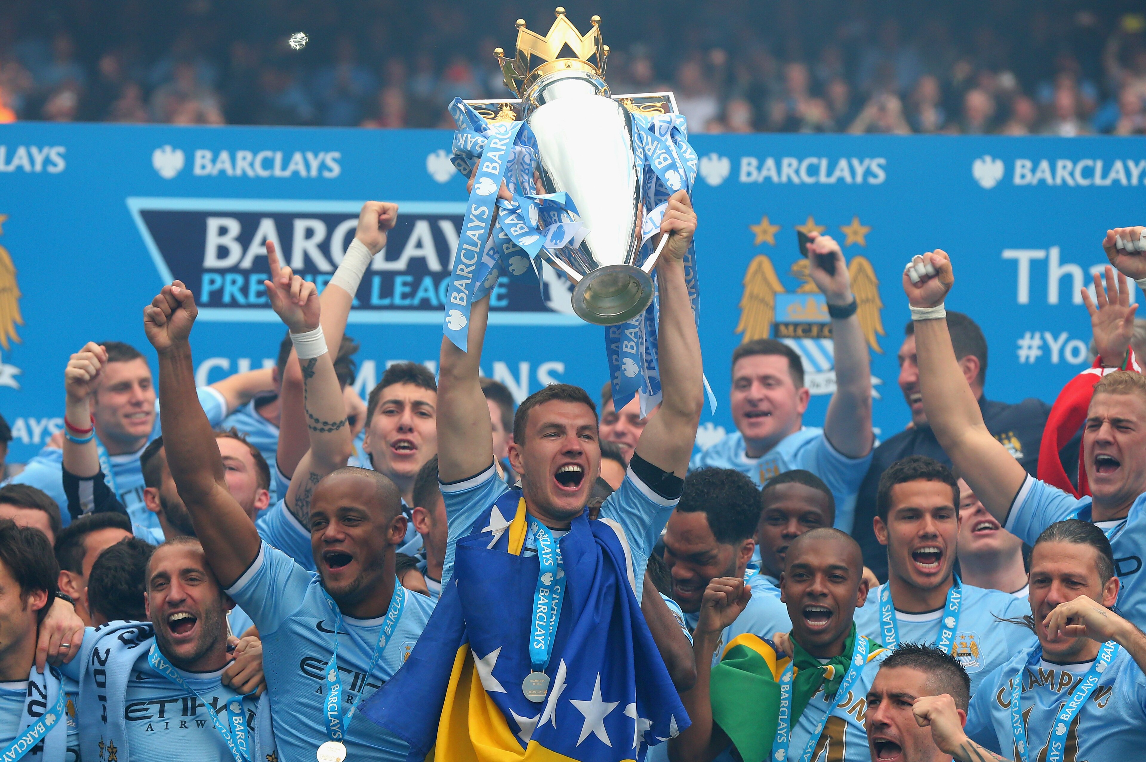 MANCHESTER, ENGLAND - MAY 11:  Edin Dzeko of Manchester City lifts the Premier League trophy at the end of the Barclays Premier League match between Manchester City and West Ham United at the Etihad Stadium on May 11, 2014 in Manchester, England.  (Photo by Alex Livesey/Getty Images)