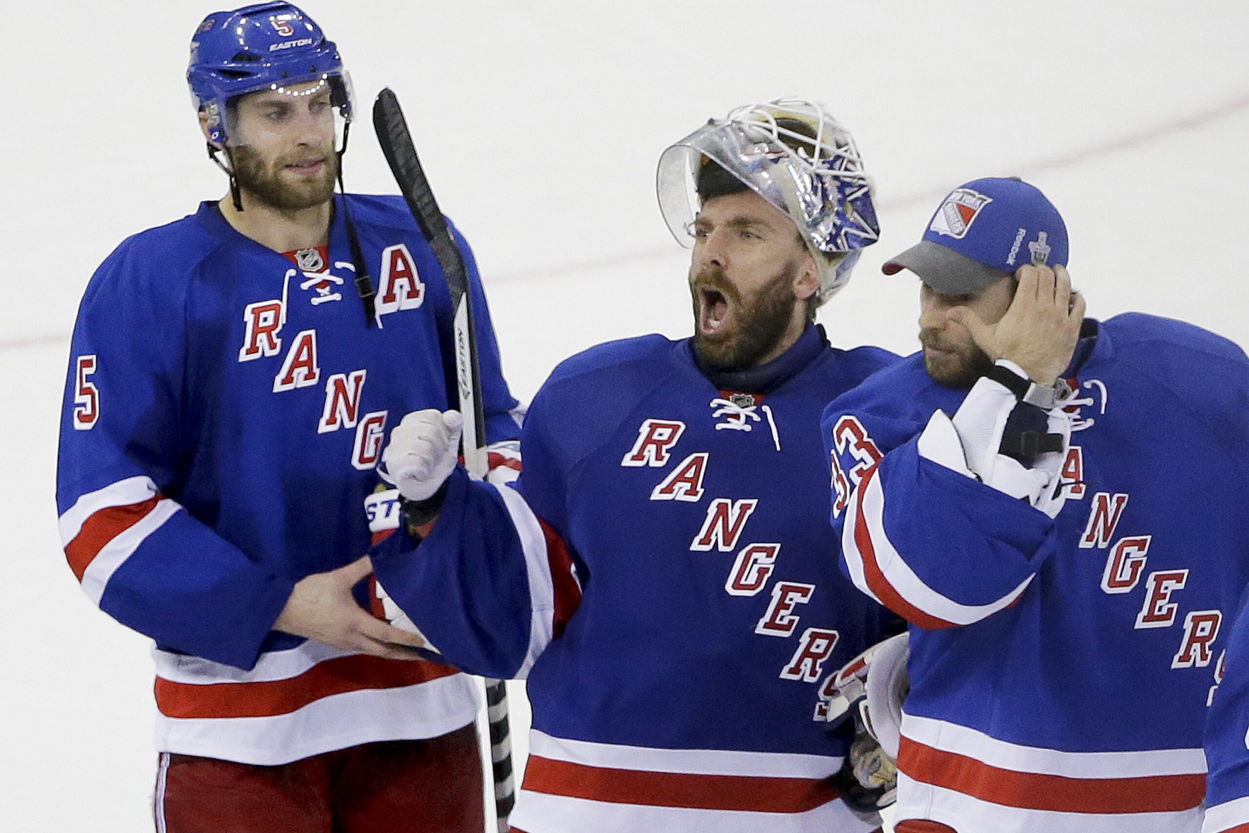 New York Rangers goalie Henrik Lundqvist, center, reacts to the crowd as teammates Dan Girardi (5) and goalie Cam Talbot (33) skate alongside him after the Rangers beat the Montreal Canadiens 1-0 in Game 6 of the NHL hockey Stanley Cup playoffs Eastern Conference finals, Thursday, May 29, 2014, in New York. The Rangers advance to the Stanley Cup Final. (AP Photo/Frank Franklin II)