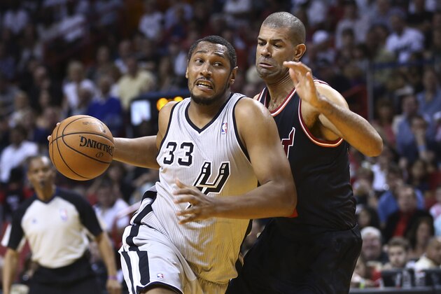 San Antonio Spurs' Boris Diaw (33) drives around Miami Heat's Shane Battier (31) during the first half of a NBA basketball game in Miami, Sunday, Jan. 26, 2014. (AP Photo/J Pat Carter)