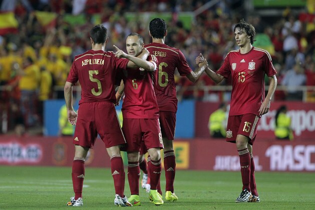 Spain's Andres iniesta, second left, celebrates with teammate Cesar Azpilicueta, left, after scoring against Bolivia during their friendly soccer match in Seville, Spain on Friday, May 30. 2014. (AP Photo/Miguel Angel Morenatti)
