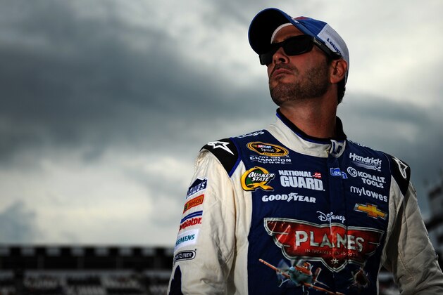 LONG POND, PA - AUGUST 02:  Jimmie Johnson, driver of the #48 Lowe's Planes Chevrolet, stands on the grid after qualifying on the pole for the NASCAR Sprint Cup Series GoBowling.com 400 at Pocono Raceway on August 2, 2013 in Long Pond, Pennsylvania.  (Photo by Jared C. Tilton/Getty Images)