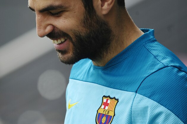FC Barcelona's Cesc Fabregas smiles during a training session at the Sports Center FC Barcelona Joan Gamper in San Joan Despi, Spain, Saturday, March 22, 2014. Real Madrid will play against FC Barcelona in a Spanish La Liga soccer match next Sunday 23 March. (AP Photo/Manu Fernandez)