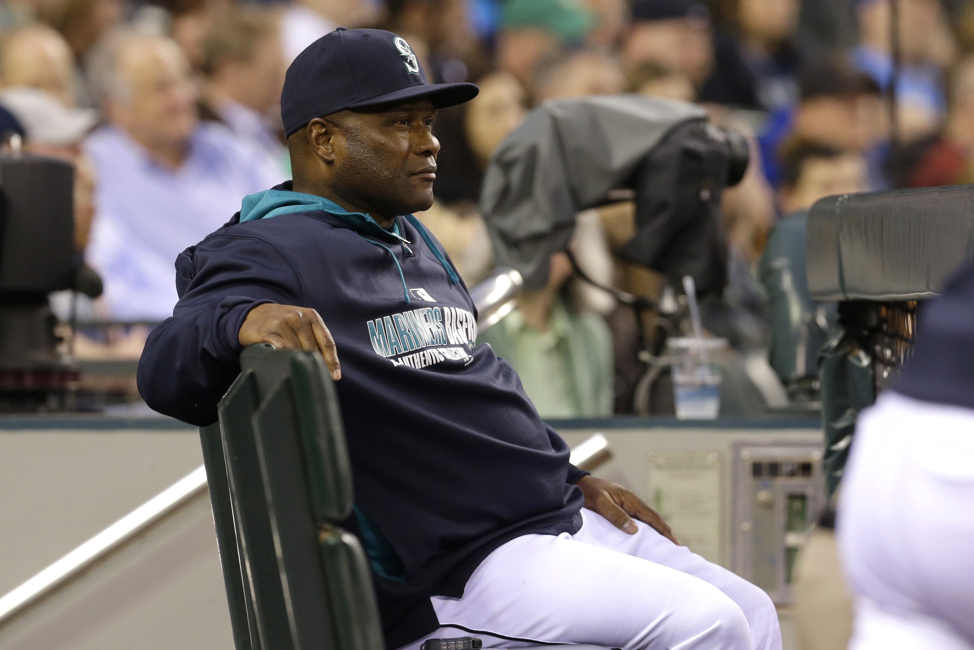 Seattle Mariners manager Lloyd McClendon sits on a bench near the dugout rail Thursday, May 22, 2014, during a baseball game against the Houston Astros in Seattle. (AP Photo/Ted S. Warren)
