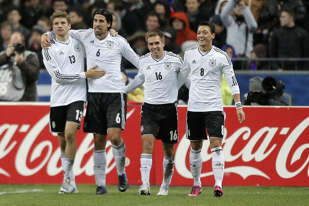 Germany's Sami Khedira, 2nd left, celebrates scoring his side's 2nd goal with teammates Thomas Mueller,  Philipp Lahm and Mesut Oezil, from left, during the soccer friendly match between France and Germany in the Stade de France in Saint-Denis, France, Wednesday, Feb.6,2013. (AP Photo/Francois Mori)