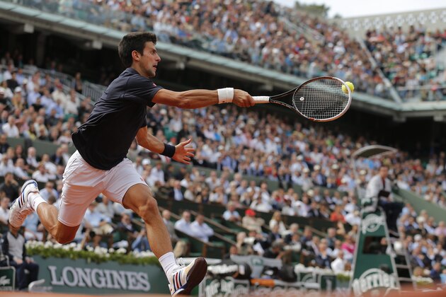 Serbia's Novak Djokovic returns the ball during the quarterfinal match of the French Open tennis tournament against Canada's Milos Raonic at the Roland Garros stadium, in Paris, France, Tuesday, June 3, 2014.  (AP Photo/Michel Spingler)