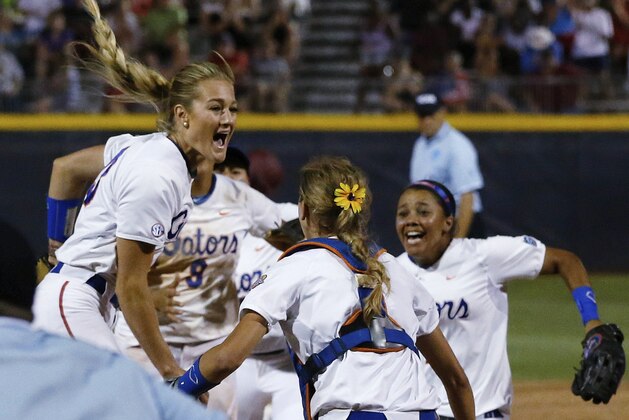 Florida pitcher Hannah Rogers, left, celebrates with teammates Aubree Munro (1) and Kelsey Stewart, right, following an NCAA Women's College World Series softball tournament game in Oklahoma City, Tuesday, June 3, 2014. Florida defeated Alabama 6-3 and won the title. (AP Photo/Sue Ogrocki)