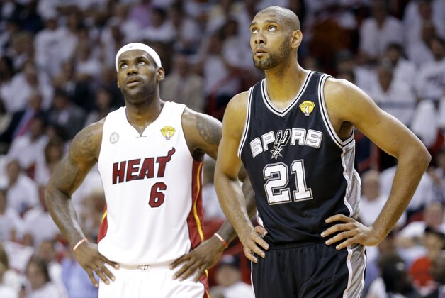 Miami Heat  forward LeBron James (6) and San Antonio Spurs  forward Tim Duncan (21) during the first  half of Game 1 of the NBA Finals basketball game, Thursday, June 6, 2013 in Miami. (AP Photo/Lynne Sladky)