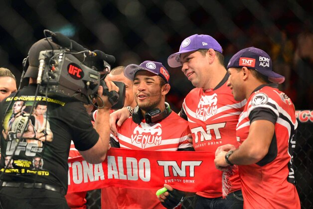 Aug 3, 2013; Rio De Janeiro, Brazil; Jose Aldo (red gloves) celebrates his victory over Chan Sung Jung during UFC 163 at HSBC Arena. Mandatory Credit: Jason Silva-USA TODAY Sports