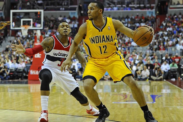 May 9, 2014; Washington, DC, USA; Indiana Pacers small forward Evan Turner (12) dribbles the ball as Washington Wizards shooting guard Bradley Beal (3) defends during the first half in game three of the second round of the 2014 NBA Playoffs at Verizon Center. Mandatory Credit: Brad Mills-USA TODAY Sports