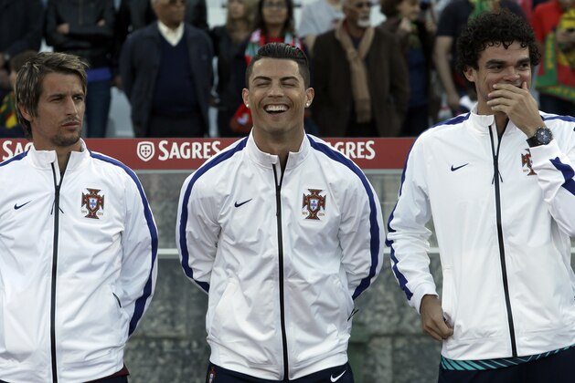 Portugal's Cristiano Ronaldo, centre, laughs with teammates Fabio Coentrao, left, and Pepe prior a friendly soccer match between Portugal and Greece at the National stadium, in Oeiras, near Lisbon, Saturday, May 31, 2014. The game was a warm-up match for both teams ahead the World Cup in Brazil. The match ended in a 0-0 draw. (AP Photo/Francisco Seco)