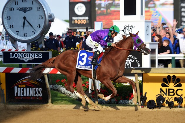 BALTIMORE, MD - MAY 17:  California Chrome #3, ridden by Victor Espinoza, races past the finishline to win during the 139th running of the Preakness Stakes at Pimlico Race Course on May 17, 2014 in Baltimore, Maryland.  (Photo by Jim Dietz/Getty Images)