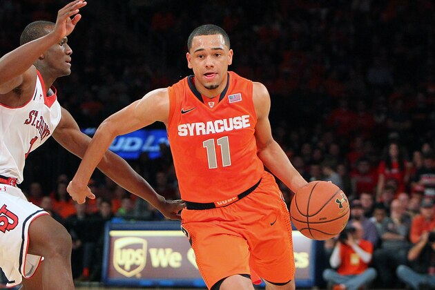 NEW YORK, NY - DECEMBER 15:  Tyler Ennis #11 of the Syracuse Orange drives the ball down the court against Phil Greene IV #1 of the St. John's Red Storm during the game at Madison Square Garden on December 15, 2013 in New York City. (Photo by Nate Shron/Getty Images)