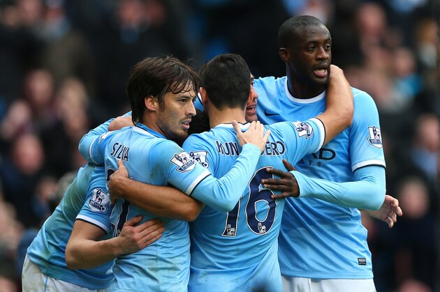 MANCHESTER, ENGLAND - DECEMBER 14:  David Silva, Pablo Zabaleta, Yaya Toure, Sergio Aguero of Manchester City celebrate with Alvaro Negredo of Manchester City after he scored their second goal during the Barclays Premier League match between Manchester City and Arsenal at Etihad Stadium on December 14, 2013 in Manchester, England.  (Photo by Clive Brunskill/Getty Images)