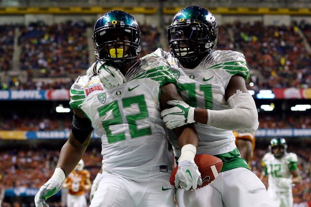 SAN ANTONIO, TX - DECEMBER 30: Linebacker Derrick Malone #22 celebrates a pick six with defensive end Tony Washington #91 of the Oregon Ducks against the Texas Longhorns during the Valero Alamo Bowl at the Alamodome on December 30, 2013 in San Antonio, Texas.  (Photo by Ronald Martinez/Getty Images)