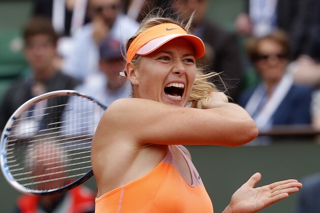 Russia's Maria Sharapova returns the ball to Spain's Garbine Muguruza during their quarterfinal match of  the French Open tennis tournament at the Roland Garros stadium, in Paris, France, Tuesday, June 3, 2014. (AP Photo/Michel Euler)