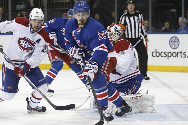 Montreal Canadiens defenseman Josh Gorges (26) defends as New York Rangers left wing Chris Kreider (20) gets the puck in front of Canadiens goalie Dustin Tokarski (35) during the second period of Game 3 of the NHL hockey Stanley Cup playoffs Eastern Conference finals, Thursday, May 22, 2014, in New York. (AP Photo/Kathy Willens)