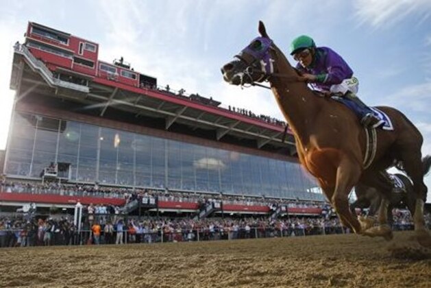 California Chrome, ridden by jockey Victor Espinoza, wins the 139th Preakness Stakes horse race at Pimlico Race Course, Saturday, May 17, 2014, in Baltimore.  (AP Photo/Matt Slocum)