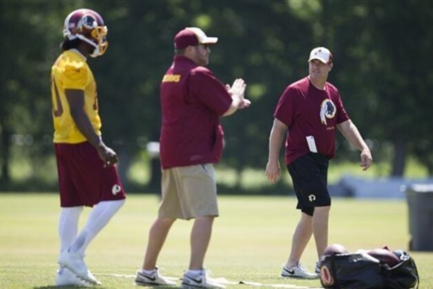 Washington Redskins head coach Jay Gruden, right, looks on during an NFL football practice at Redskins Park, on Wednesday, June 4, 2014, in Ashburn, Va. (AP Photo/ Evan Vucci)