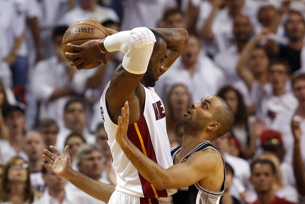 Jun 18, 2013; Miami, FL, USA; San Antonio Spurs point guard Tony Parker (9) defends Miami Heat small forward LeBron James (6) during the fourth quarter of game six in the 2013 NBA Finals at American Airlines Arena.  Mandatory Credit: Derick E. Hingle-USA TODAY Sports