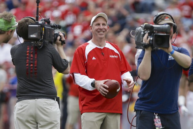 Nebraska head coach Bo Pelini laughs as he is followed by television cameras during Nebraska's NCAA college football spring game in Lincoln, Neb., Saturday, April 12, 2014. (AP Photo/Nati Harnik)