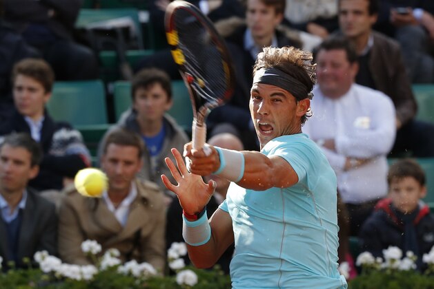 Spain's Rafael Nadal returns the ball to compatriot David Ferrer during their quarterfinal match of  the French Open tennis tournament at the Roland Garros stadium, in Paris, France, Wednesday, June 4, 2014. (AP Photo/Michel Euler)
