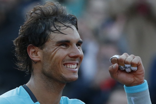 Spain's Rafael Nadal celebrates winning the quarterfinal match of the French Open tennis tournament against compatriot David Ferrer at the Roland Garros stadium, in Paris, France, Wednesday, June 4, 2014. Nadal won in four sets 4-6, 6-4, 6-0, 6-1. (AP Photo/Michel Euler)