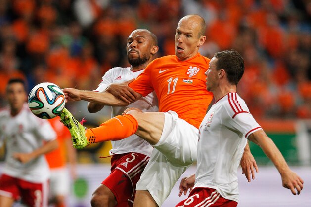 AMSTERDAM, NETHERLANDS - JUNE 04:  Arjen Robben of Netherlands attempts to control the ball betweeen Daniel Gabbidon and James Chester of Wales during the International Friendly match between The Netherlands and Wales at Amsterdam Arena on June 4, 2014 in Amsterdam, Netherlands.  (Photo by Dean Mouhtaropoulos/Getty Images)