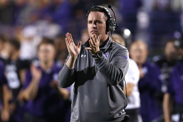 Northwestern head coach Pat Fitzgerald applauds his team during the first half of an NCAA football game against Ohio State, Saturday, Oct. 5, 2013, in Evanston, Ill. (AP Photo/Charles Rex Arbogast)