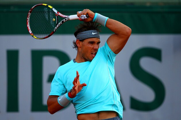 PARIS, FRANCE - JUNE 04:  Rafael Nadal of Spain returns a shot during his men's singles quarter-final match against David Ferrer of Spain on day eleven of the French Open at Roland Garros on June 4, 2014 in Paris, France.  (Photo by Dan Istitene/Getty Images)