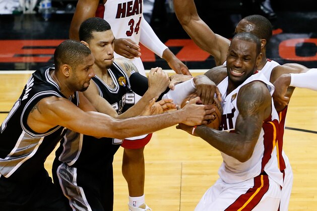 MIAMI, FL - JUNE 18:  Tim Duncan #21 and Danny Green #4 of the San Antonio Spurs battle for the ball against LeBron James #6 and Dwyane Wade #3 of the Miami Heat in overtime during Game Six of the 2013 NBA Finals at AmericanAirlines Arena on June 18, 2013 in Miami, Florida. NOTE TO USER: User expressly acknowledges and agrees that, by downloading and or using this photograph, User is consenting to the terms and conditions of the Getty Images License Agreement.  (Photo by Kevin C. Cox/Getty Images)