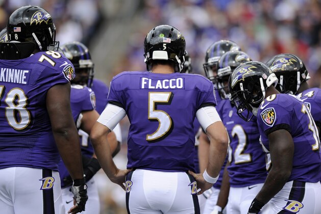 Baltimore Ravens quarterback Joe Flacco (5) huddles with teammates in the first half of an NFL football game against the Houston Texans, Sunday, Sept. 22, 2013, in Baltimore. (AP Photo/Nick Wass)