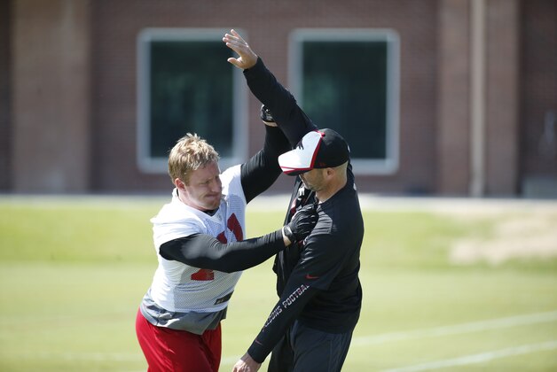 Atlanta Falcons defensive end Kroy Biermann (71) works with linebackers coach Mark Collins during an off-season practice, Wednesday, May 28, 2014 in Flowery Branch, Ga. (AP Photo/John Bazemore)