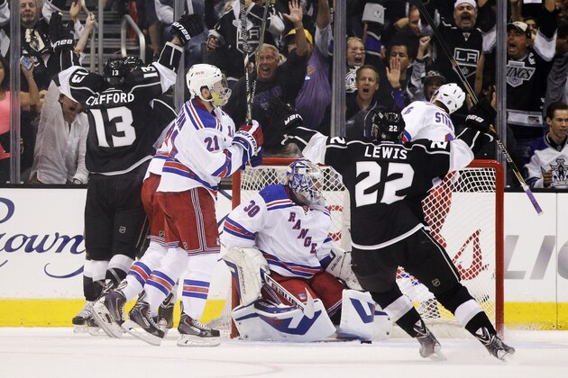 Los Angeles Kings left wing Kyle Clifford (13) and Trevor Lewis (22) celebrate a goal by Clifford during the first period of Game 1 in the NHL Stanley Cup Final hockey series against the New York Rangers on Wednesday, June 4, 2014, in Los Angeles.(AP Photo/Jae C. Hong)