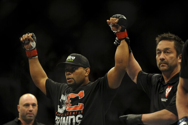 Feb 22, 2014; Las Vegas, NV, USA;  Daniel Cormier (red gloves) celebrates his victory of Pactrick Cummins (not pictured) after their UFC light heavyweight bout at Mandalay Bay. Cormier won by way of a TKO in the first round. Mandatory Credit: Stephen R. Sylvanie-USA TODAY Sports