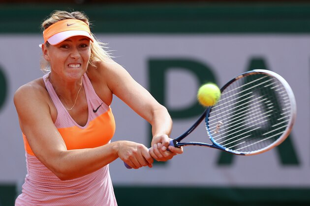 PARIS, FRANCE - JUNE 05:  Maria Sharapova of Russia returns a shot during her women's singles semi-final match against Eugenie Bouchard of Canada on day twelve of the French Open at Roland Garros on June 5, 2014 in Paris, France.  (Photo by Matthew Stockman/Getty Images)