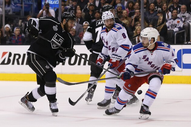 LOS ANGELES, CA - JUNE 04:  Dwight King #74 of the Los Angeles Kings fights for the puck against Raphael Diaz #4 of the New York Rangers during Game One of the 2014 NHL Stanley Cup Final at the Staples Center on June 4, 2014 in Los Angeles, California.  (Photo by Bruce Bennett/Getty Images)