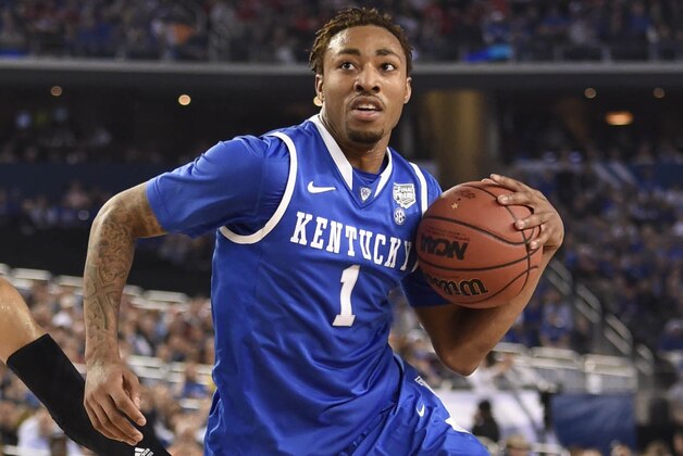 Apr 5, 2014; Arlington, TX, USA; Kentucky Wildcats guard/forward James Young (1) drives past Wisconsin Badgers guard Traevon Jackson (12) int he first half during the semifinals of the Final Four in the 2014 NCAA Mens Division I Championship tournament at AT&T Stadium. Mandatory Credit: Bob Donnan-USA TODAY Sports