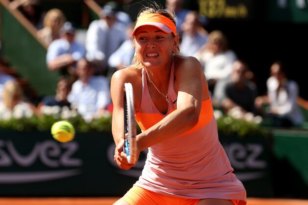 PARIS, FRANCE - JUNE 05:  Maria Sharapova of Russia returns a shot during her women's singles semi-final match against Eugenie Bouchard of Canada on day twelve of the French Open at Roland Garros on June 5, 2014 in Paris, France.  (Photo by Matthew Stockman/Getty Images)