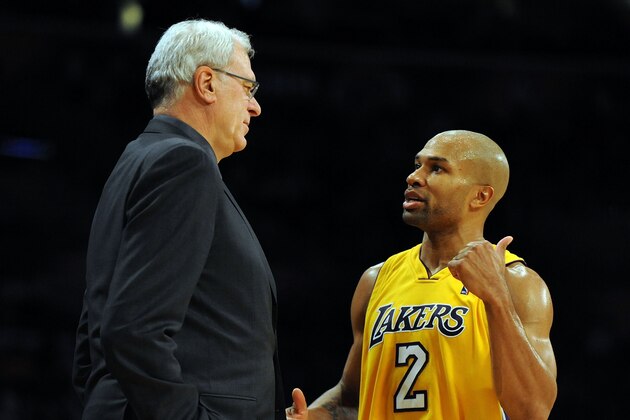 LOS ANGELES, CA - DECEMBER 01:  Derek Fisher #2 of the Los Angeles Lakers speaks to Head Coach Phil Jackson during the game against the New Orleans Hornets at Staples Center on December 1, 2009 in Los Angeles, California.  (Photo by Harry How/Getty Images) NOTE TO USER: User expressly acknowledges and agrees that, by downloading and/or using this Photograph, user is consenting to the terms and conditions of the Getty Images License Agreement.