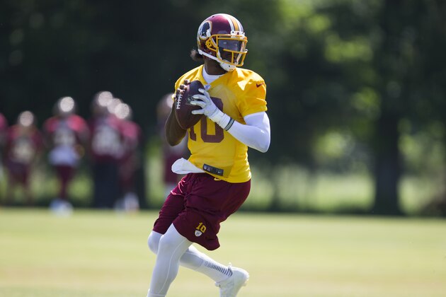 Washington Redskin quarterback Robert Griffin III throws a pass during an NFL football practice at Redskins Park, on Wednesday, June 4, 2014, in Ashburn, Va. (AP Photo/ Evan Vucci)