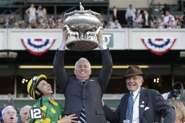Trainer Todd Pletcher, center, hoists the Belmont Stakes trophy in the winner's circle while standing with jockey Mike Smith, left, and Cot Campbell, President of Dogwood Stables, after Palace Malice won the Belmont Stakes horse race in Elmont, N.Y., Saturday, June 8, 2013. (AP Photo/Seth Wenig) Trainer Todd Pletcher, center, hoists the Belmont Stakes trophy in the winner's circle while standing with jockey Mike Smith, left, and Cot Campbell, President of Dogwood Stables, after Palace Malice won the Belmont Stakes horse race in Elmont, N.Y., Saturday, June 8, 2013. (AP Photo/Seth Wenig)