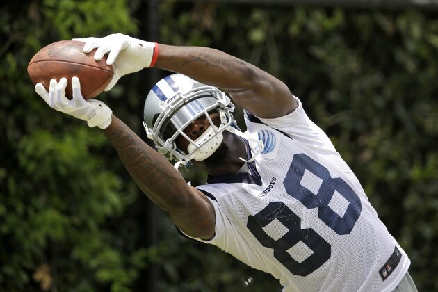Dallas Cowboys wide receiver Dez Bryant grabs a pass from a throwing machine during an NFL football organized team activity, Tuesday, May 27, 2014, in Irving, Texas. (AP Photo/Tony Gutierrez)
