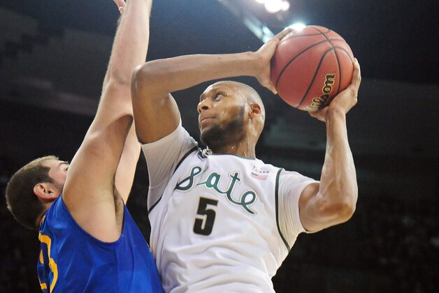 SPOKANE, WA - MARCH 20:  Adreian Payne #5 of the Michigan State Spartans shoots over Carl Baptiste #33 of the Delaware Fightin Blue Hens during the second round of the 2014 NCAA Men's Basketball Tournament at Spokane Veterans Memorial Arena on March 20, 2014 in Spokane, Washington.  (Photo by Steve Dykes/Getty Images)