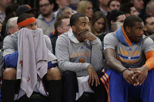 New York Knicks' Carmelo Anthony, left, J.R. Smith, center, and Amar'e Stoudemire, right, watch their team play during the first half of an NBA basketball game against the Philadelphia 76ers Monday, March 10, 2014, in New York. (AP Photo/Frank Franklin II)