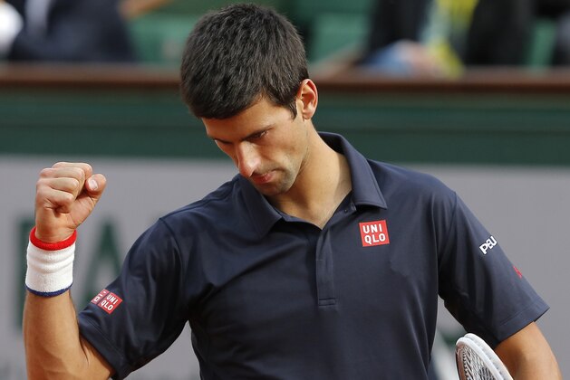 Serbia's Novak Djokovic clenches his fost as he defeats Canada's Milos Raonic during their quarterfinal match of  the French Open tennis tournament at the Roland Garros stadium, in Paris, France, Tuesday, June 3, 2014. Djokovic won 7-5, 7-6, 6-4. (AP Photo/Michel Spingler)